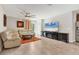 Bright living room with stylish sectional sofa, ceiling fan, large TV, and view of dining area at 5033 Brickwood Rise Dr, Wimauma, FL 33598