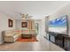 Spacious living room featuring a comfortable sectional sofa, large TV, ceiling fan, and contemporary decor at 5033 Brickwood Rise Dr, Wimauma, FL 33598