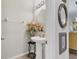 This powder room features a pedestal sink and modern lighting at 5033 Brickwood Rise Dr, Wimauma, FL 33598