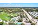 This aerial view showcases the community, golf course, and road, highlighting the neighborhood layout at 52 Grande Fairway, Englewood, FL 34223