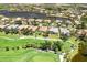Aerial view showcases the property's location on a golf course, near a lake, and neighborhood at 52 Grande Fairway, Englewood, FL 34223