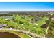Expansive aerial view of the golf course, with winding fairways and scenic water hazards at 52 Grande Fairway, Englewood, FL 34223