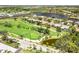 An aerial view of the property situated on a golf course near a pond at 52 Grande Fairway, Englewood, FL 34223