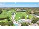 Scenic aerial view of the golf course community with lush greenery and several water features at 52 Grande Fairway, Englewood, FL 34223