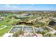 Overhead view showcasing the community's tennis courts, surrounding homes, and water features at 52 Grande Fairway, Englewood, FL 34223