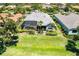 Aerial shot of the backyard featuring a screened-in pool and lush greenery, offering privacy at 52 Grande Fairway, Englewood, FL 34223
