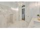 Elegant bathroom featuring marble tiling throughout, a modern shower, and stylish lighting fixtures at 52 Grande Fairway, Englewood, FL 34223