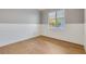Bright bedroom with wood flooring, wainscoting accent, and a sunlit window at 52 Grande Fairway, Englewood, FL 34223