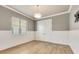 Minimalist bedroom featuring light gray walls, modern flooring, and natural light at 52 Grande Fairway, Englewood, FL 34223