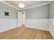 Cozy bedroom with hardwood floors, shiplap accent, and a neutral color scheme at 52 Grande Fairway, Englewood, FL 34223