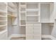 Walk-in closet with custom shelving and drawers, providing ample storage space and organization at 52 Grande Fairway, Englewood, FL 34223