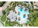 Aerial view of the community pool featuring a unique design and surrounded by tropical landscaping at 52 Grande Fairway, Englewood, FL 34223