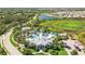 Aerial view of the community pool, a great amenity, surrounded by lush tropical landscaping at 52 Grande Fairway, Englewood, FL 34223