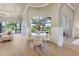 Bright dining area with elegant furnishings and a view of the outdoor pool and golf course at 52 Grande Fairway, Englewood, FL 34223