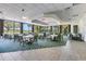 Bright dining room with beautiful golf course views, chandelier, and seating for large parties at 52 Grande Fairway, Englewood, FL 34223