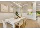 Charming dining room with modern light fixture, stylish chairs, and a serene ambiance at 52 Grande Fairway, Englewood, FL 34223