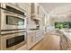 Gourmet kitchen with stainless steel appliances, marble countertops, and hardwood flooring at 52 Grande Fairway, Englewood, FL 34223