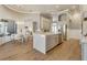 Bright open kitchen with stainless steel appliances, marble countertops, and hardwood flooring at 52 Grande Fairway, Englewood, FL 34223