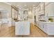 Spacious kitchen with stainless steel appliances, marble countertops, an island with seating, and hardwood flooring at 52 Grande Fairway, Englewood, FL 34223