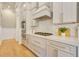 Gourmet kitchen with stainless steel appliances, marble countertops, and custom cabinetry at 52 Grande Fairway, Englewood, FL 34223
