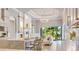 Open-concept kitchen boasts a large island, stylish barstools, and sliding glass doors to the outdoor area at 52 Grande Fairway, Englewood, FL 34223