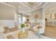 Open-concept living room featuring stylish furniture, archways, tray ceilings, and wood-look flooring at 52 Grande Fairway, Englewood, FL 34223