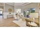 Bright and airy living room with tray ceilings, and sliding glass doors to the outdoor living area at 52 Grande Fairway, Englewood, FL 34223