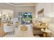 Elegant living room featuring stylish furniture, high ceilings, and sliding glass doors to the outdoor living area at 52 Grande Fairway, Englewood, FL 34223