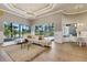 Bright living room with high ceilings, large windows, and access to the outdoor pool area at 52 Grande Fairway, Englewood, FL 34223