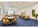 Relaxing lounge featuring bright lighting, comfortable seating, and cozy fireplace at 52 Grande Fairway, Englewood, FL 34223