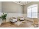 Bright office space with modern decor, featuring a large window and stylish seating at 52 Grande Fairway, Englewood, FL 34223