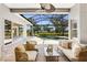 Covered patio with a seating area and a view of the pool, spa, and manicured backyard at 52 Grande Fairway, Englewood, FL 34223
