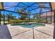 Screened-in pool area with a spa, providing a serene and private outdoor space at 52 Grande Fairway, Englewood, FL 34223