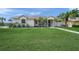 Well-maintained front lawn with lush green grass, tasteful landscaping, and a charming one-story home at 5226 Magnolia Pond Dr, Sarasota, FL 34233