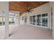 Covered patio with wood ceiling, fan and glass sliding doors overlooking the backyard at 5226 Magnolia Pond Dr, Sarasota, FL 34233