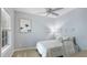 Minimalist bedroom with a ceiling fan, neutral walls, and natural light at 5450 Fairfield Blvd, Bradenton, FL 34203