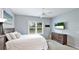 Cozy bedroom features a ceiling fan, neutral-toned decor, and a view to the exterior at 5450 Fairfield Blvd, Bradenton, FL 34203
