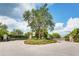 Gated community entrance with manicured landscaping, adding privacy and curb appeal at 5450 Fairfield Blvd, Bradenton, FL 34203