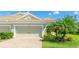 Attached two-car garage with a neutral color door and beautiful landscaping that enhances curb appeal at 5450 Fairfield Blvd, Bradenton, FL 34203