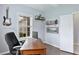 Office space features natural lighting, a built-in shelving unit, and wood flooring at 5450 Fairfield Blvd, Bradenton, FL 34203
