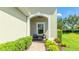 Charming covered front porch with seating area and beautiful landscaping at 5450 Fairfield Blvd, Bradenton, FL 34203