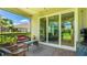 Enclosed patio has comfortable seating, plants, and sliding doors to the home at 5450 Fairfield Blvd, Bradenton, FL 34203