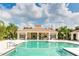 The community pool features a covered lanai with tables, seating, and barbeque area, creating a perfect outdoor retreat at 5450 Fairfield Blvd, Bradenton, FL 34203