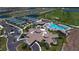 Aerial view of a luxurious community featuring pools, tennis courts, and beautiful landscaping at 5624 Palmer Cir # 101, Bradenton, FL 34211