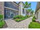Exterior view of screened in porch and manicured landscaping along sidewalk at 5624 Palmer Cir # 101, Bradenton, FL 34211