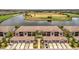 Aerial view of a charming community, featuring tile roofs, garages, and serene water and golf course views at 5624 Palmer Cir # 101, Bradenton, FL 34211