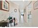 Bright hallway with tiled floors, elegant decor, and views into other living spaces at 5624 Palmer Cir # 101, Bradenton, FL 34211