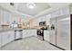 Bright kitchen with stainless steel appliances, white cabinets, and granite countertops at 5624 Palmer Cir # 101, Bradenton, FL 34211