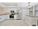 Modern kitchen with stainless steel appliances, white cabinetry, and a functional island at 5624 Palmer Cir # 101, Bradenton, FL 34211