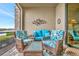 Screened-in lanai offering a beautiful lake view and comfortable seating arrangements at 5624 Palmer Cir # 101, Bradenton, FL 34211